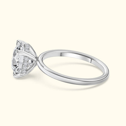 Elegant silver engagement ring featuring a large central diamond and delicate side stones.