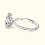Elegant silver engagement ring with a large diamond and smaller accent stones.