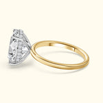 Elegant two-tone engagement ring featuring a large diamond and smaller side stones.