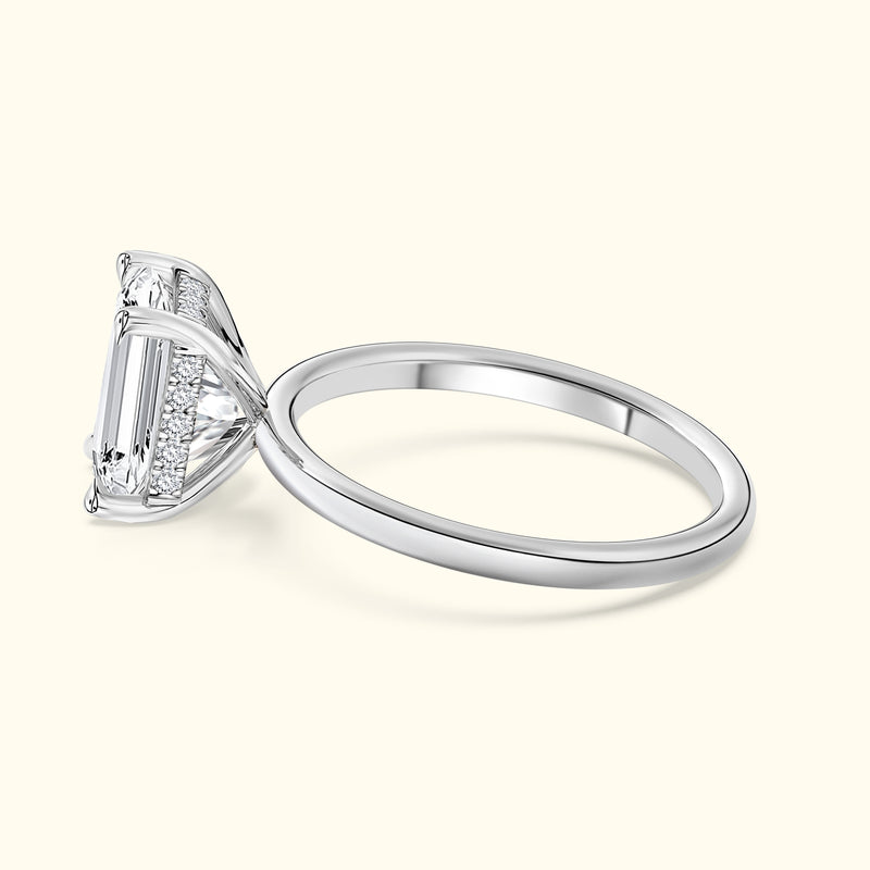 Elegant diamond engagement ring with a rectangular cut stone and a sleek silver band.