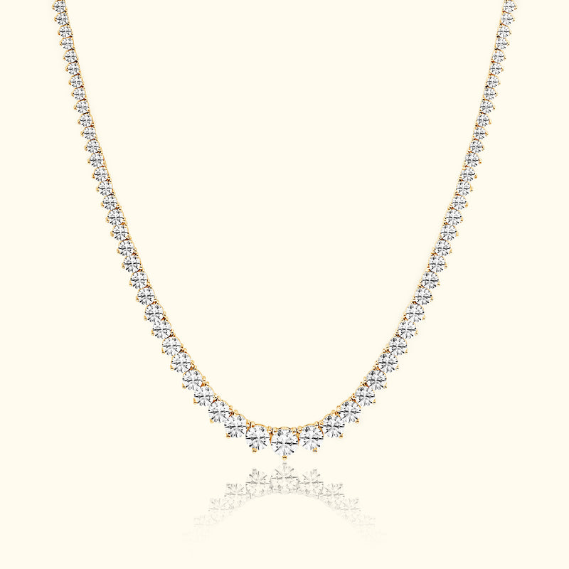 Elegant gold necklace adorned with sparkling diamonds, featuring a graduated design.