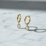 Yellow gold Huggie with a Bezel Set Oval Diamond Drop