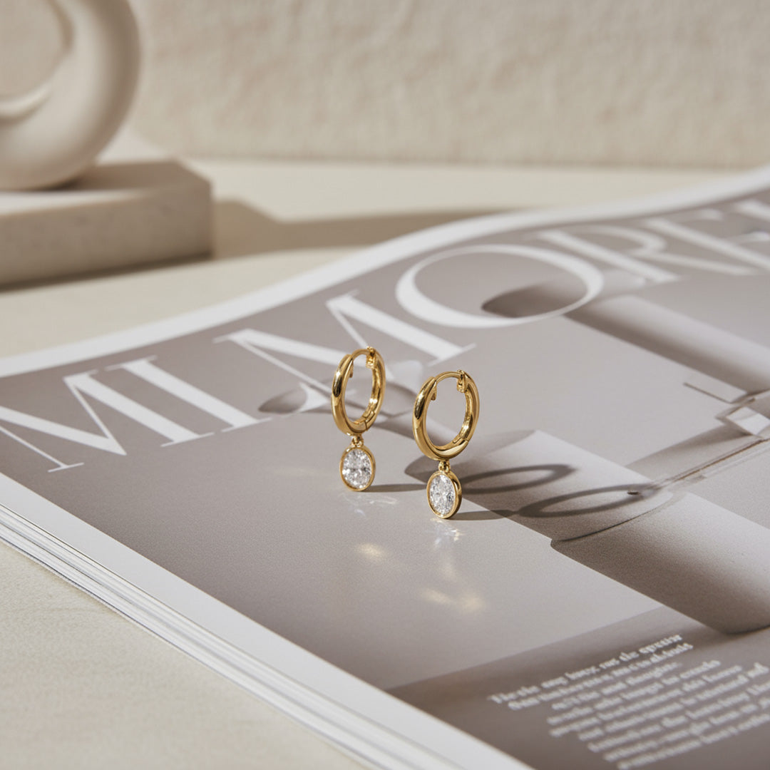 Yellow gold Huggie with a Bezel Set Oval Diamond Drop