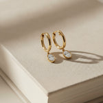 Yellow gold Huggie with a Bezel Set Oval Diamond Drop