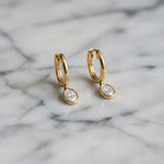 Yellow gold Huggie with a Bezel Set Oval Diamond Drop