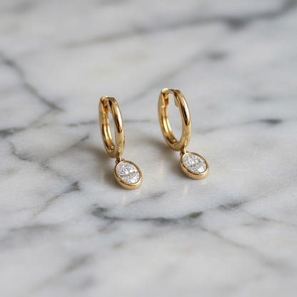 Yellow gold Huggie with a Bezel Set Oval Diamond Drop