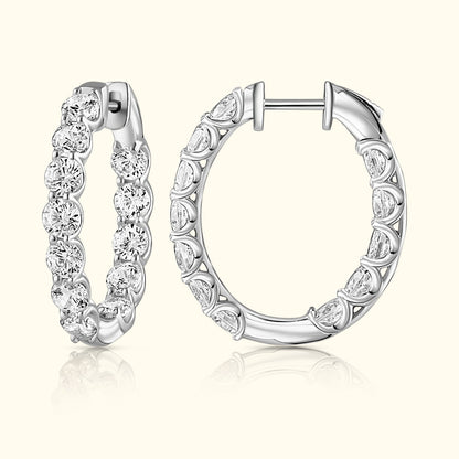 Silver hoop earrings adorned with sparkling diamonds, showcasing elegant design.