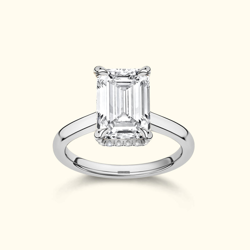 Emerald-cut diamond ring with a sleek silver band, showcasing a timeless elegance.