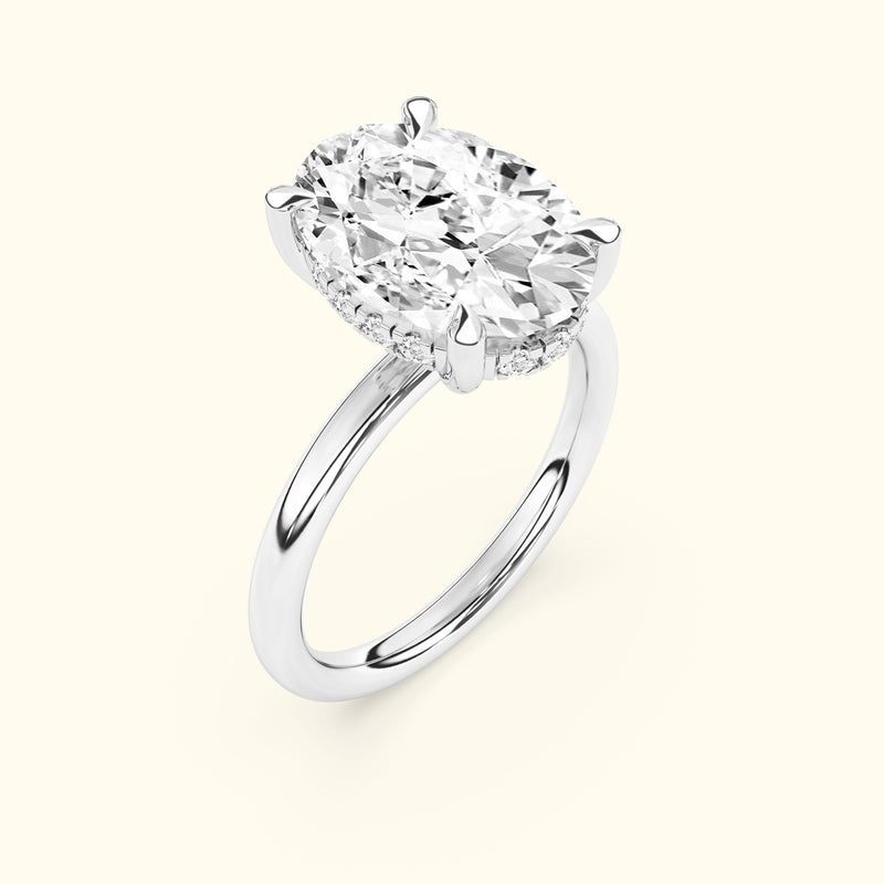 Oval diamond ring with a sleek white gold band and a sparkling halo setting.