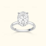 Elegant oval diamond ring set in a polished silver band with a small blue accent.