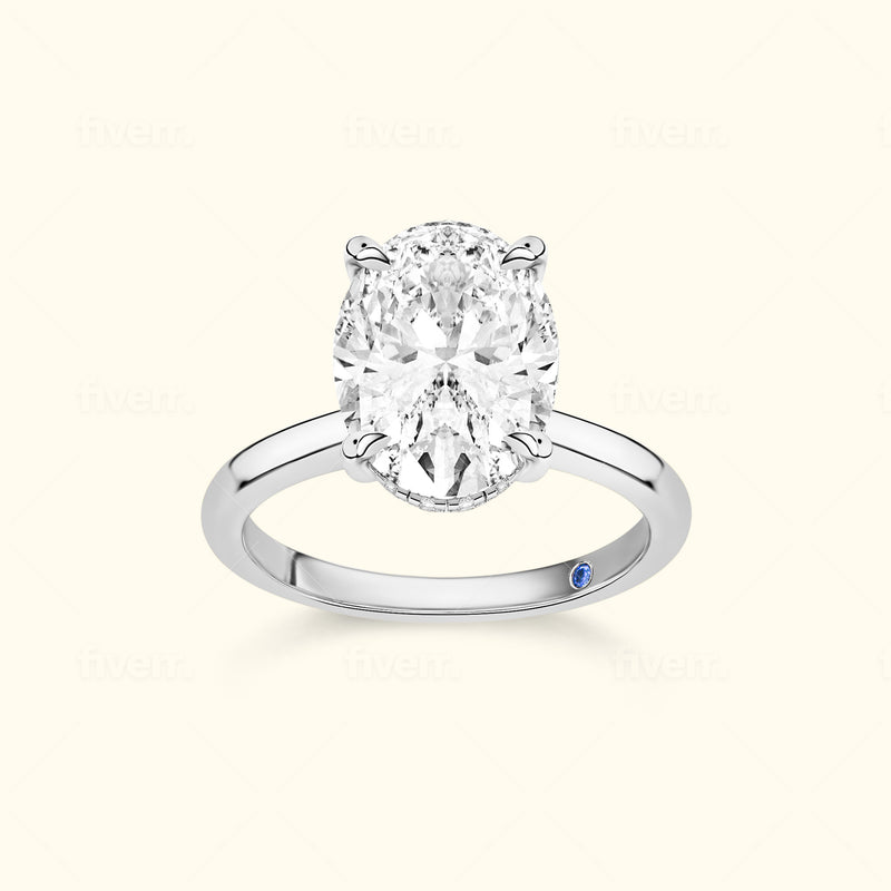 Elegant oval diamond ring set in a polished silver band with a small blue accent.