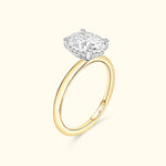 A gold ring featuring a prominent oval diamond set in a classic four-prong setting.