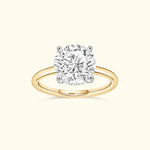 Brilliant round diamond engagement ring with a yellow gold band and white gold prongs.