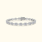 Silver bracelet with pear-shaped diamonds in a delicate arrangement.