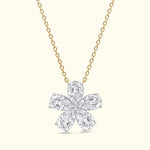 Gold chain necklace featuring a floral pendant made of pear-shaped and round diamonds.