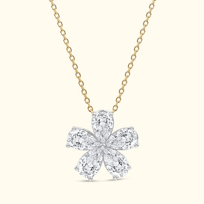 Gold chain necklace featuring a floral pendant made of pear-shaped and round diamonds.