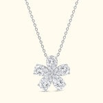 Elegant diamond flower pendant on a delicate silver chain.