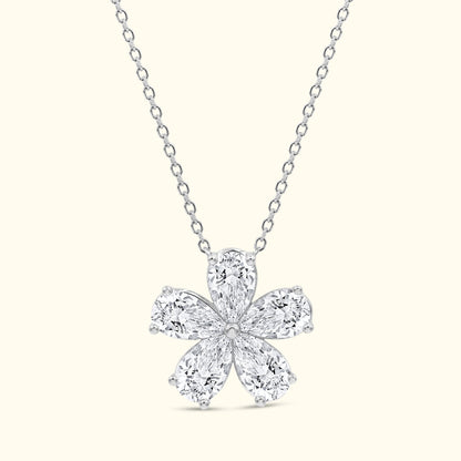 Elegant diamond flower pendant on a delicate silver chain.