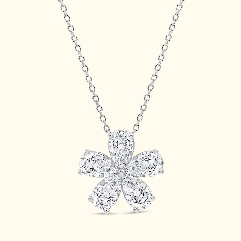 Elegant diamond flower pendant on a delicate silver chain.
