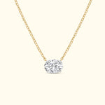Gold chain necklace featuring a large oval diamond pendant.