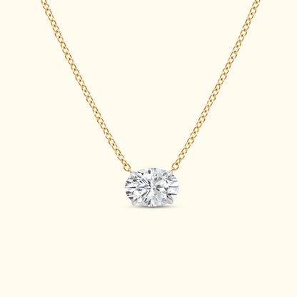 Gold chain necklace featuring a large oval diamond pendant.