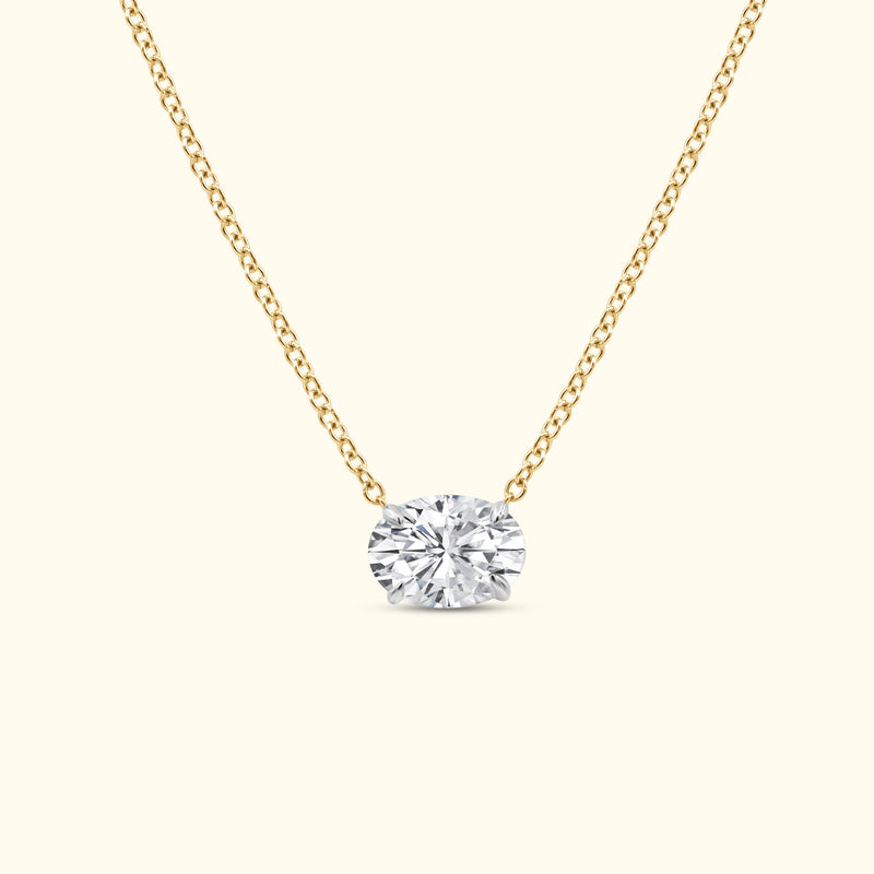 Gold chain necklace featuring a large oval diamond pendant.