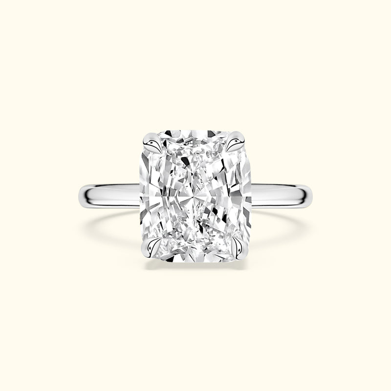 Elegant rectangular diamond ring set in a polished silver band against a light background.