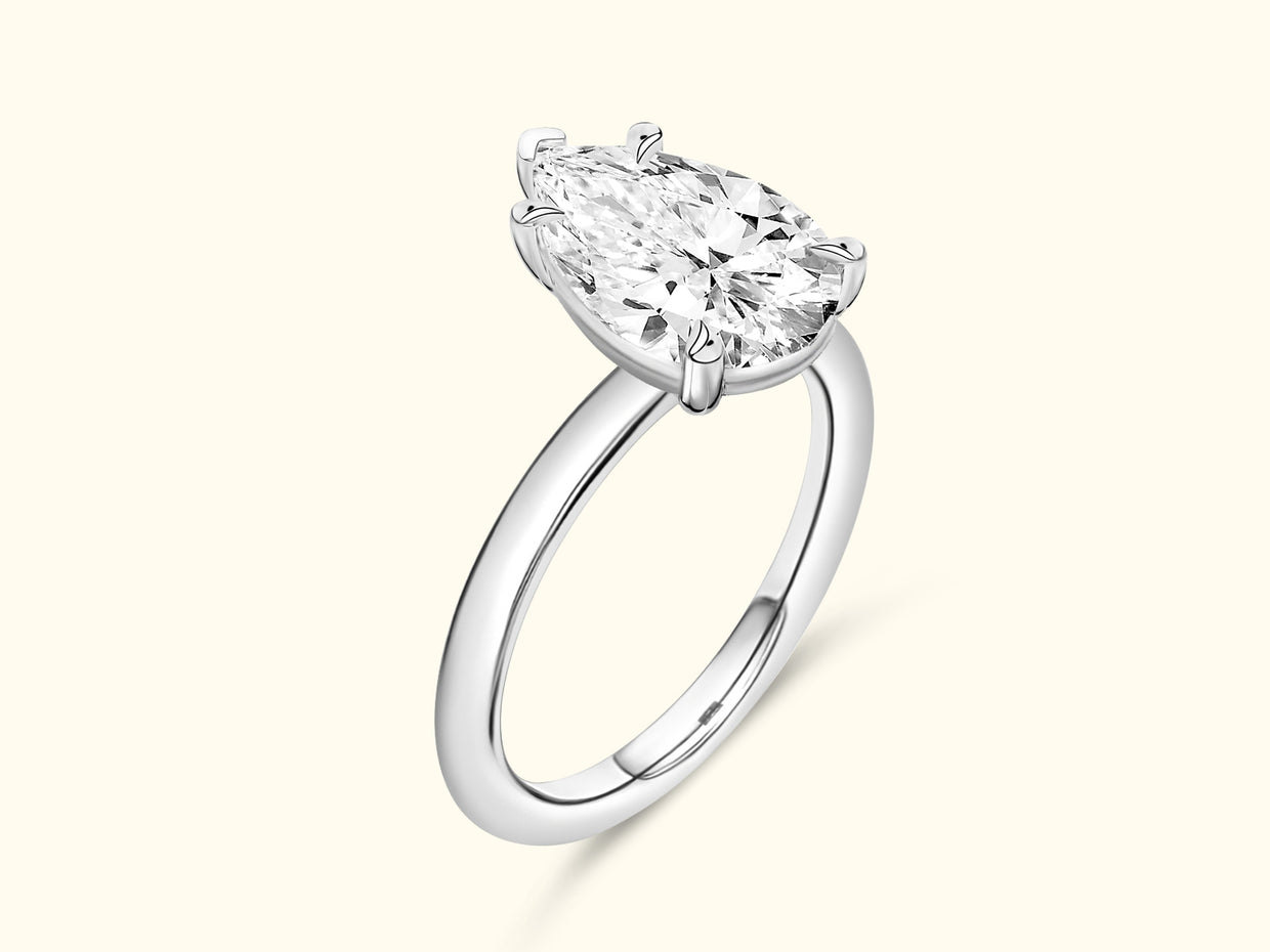 Elegant silver ring featuring a large oval diamond set in a four-prong mounting.