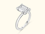 Elegant silver ring featuring a large emerald-cut diamond setting.
