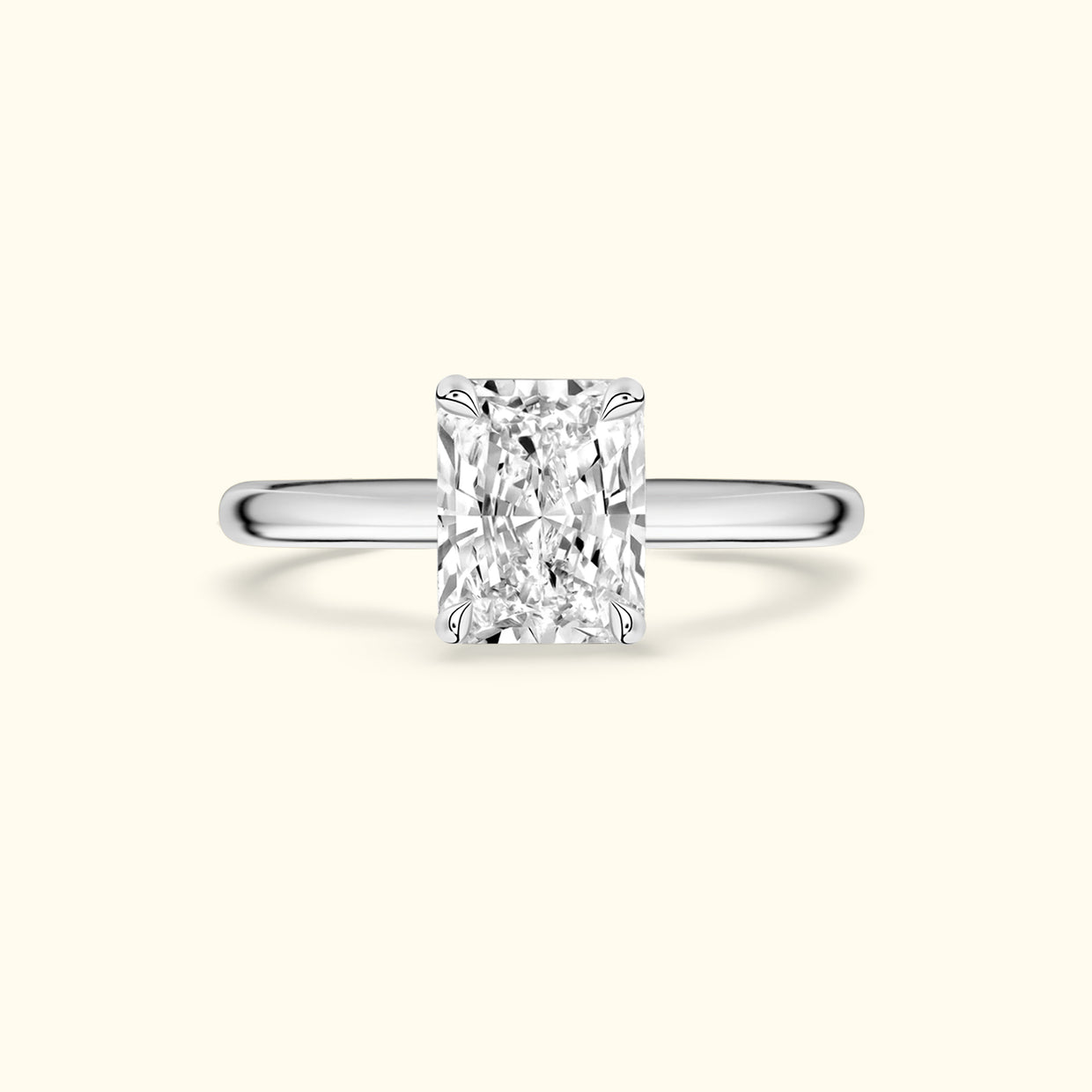 Rectangular diamond engagement ring with a sleek silver band.