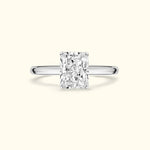 Rectangular diamond engagement ring with a sleek silver band.