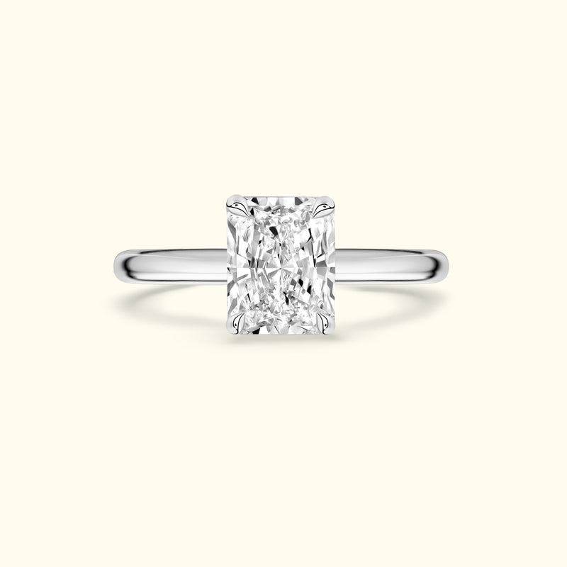 Rectangular diamond engagement ring with a sleek silver band.