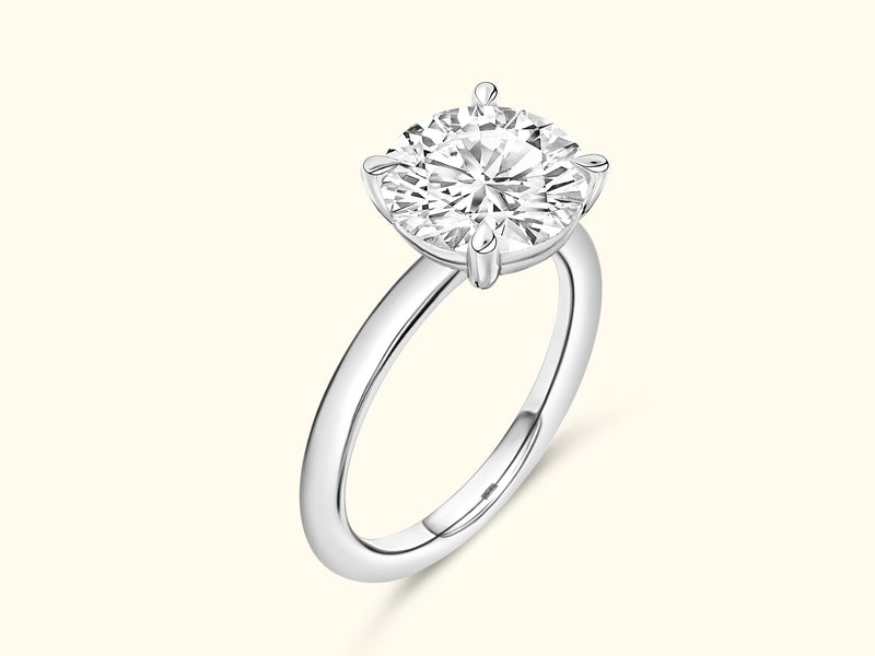 Solitaire diamond ring with a round-cut stone set in a sleek silver band.