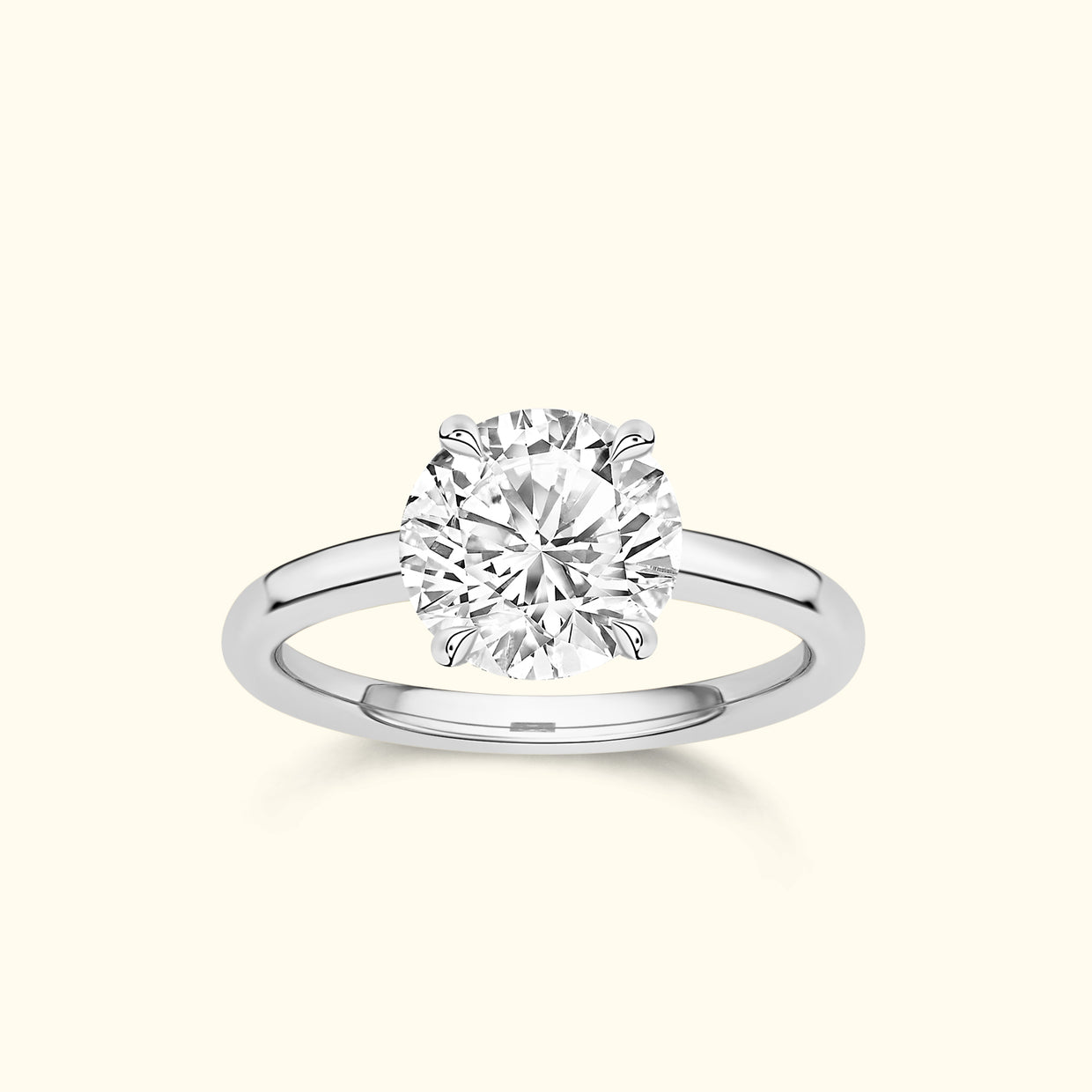 Solitaire diamond ring with a round brilliant cut stone and a polished silver band.