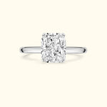 Solitaire diamond ring with a rectangular-cut center stone on a simple metal band.
