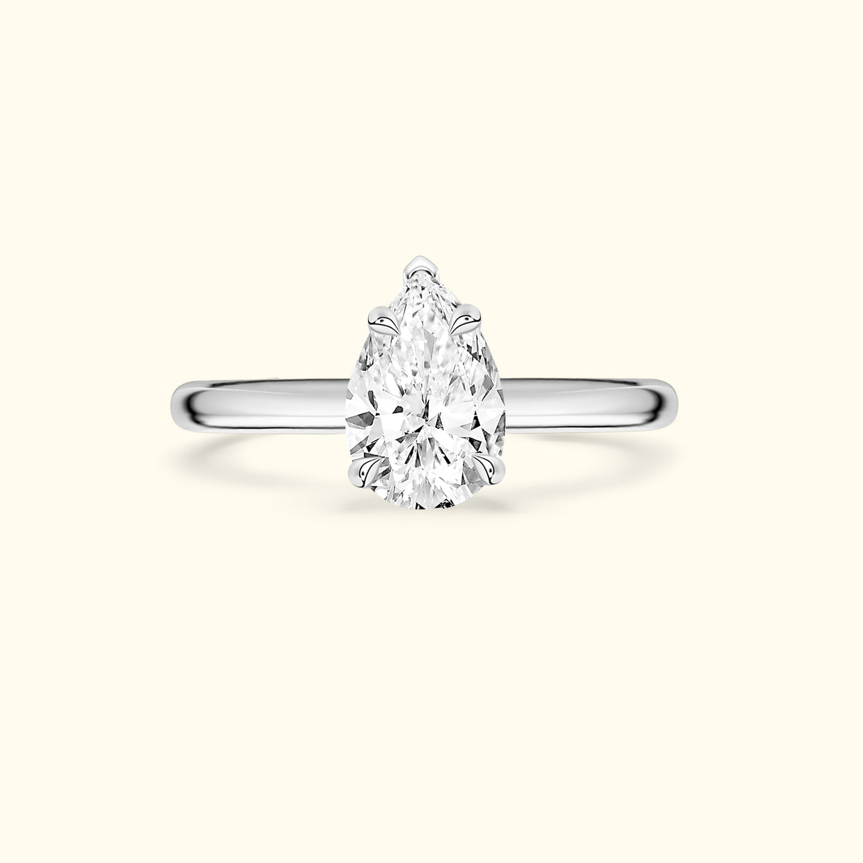 Elegant pear-shaped diamond ring with a sleek silver band.