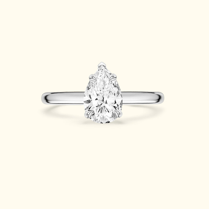 Elegant pear-shaped diamond ring with a sleek silver band.