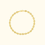 Gold chain bracelet with oval links against a light background.