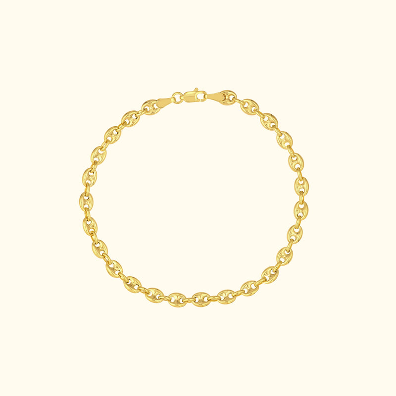 Gold chain bracelet with oval links against a light background.