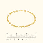 Gold chain bracelet with interlocking links, displayed against a light background.