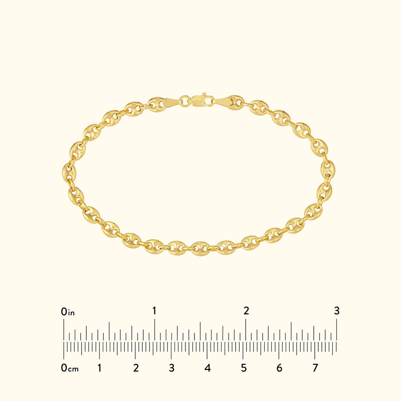 Gold chain bracelet with interlocking links, displayed against a light background.