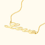 Gold necklace featuring the cursive word "Love" prominently displayed.