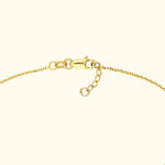 Close-up of a gold chain bracelet with a lobster clasp and adjustable links.