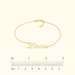 Gold bracelet featuring the word "Love" in a cursive font.
