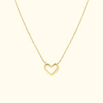 Gold heart-shaped pendant necklace on a delicate chain.