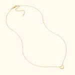 Delicate gold necklace with a small heart pendant.