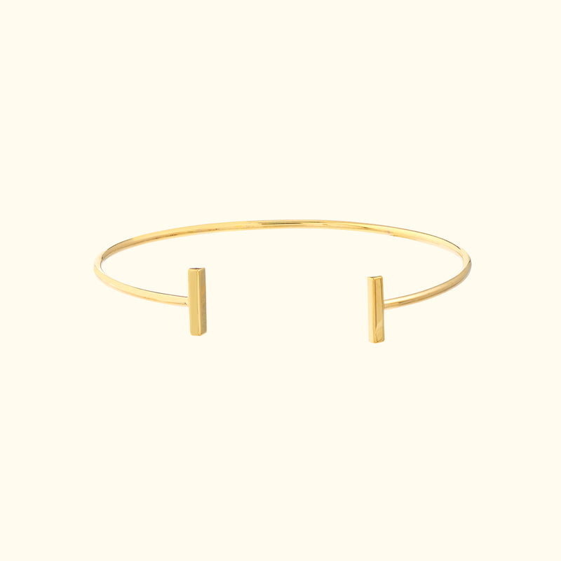 Minimalist gold cuff bracelet with two sleek vertical ends.