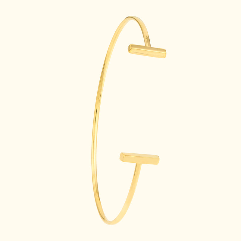 Sleek gold cuff bracelet with two minimalist rectangular ends.