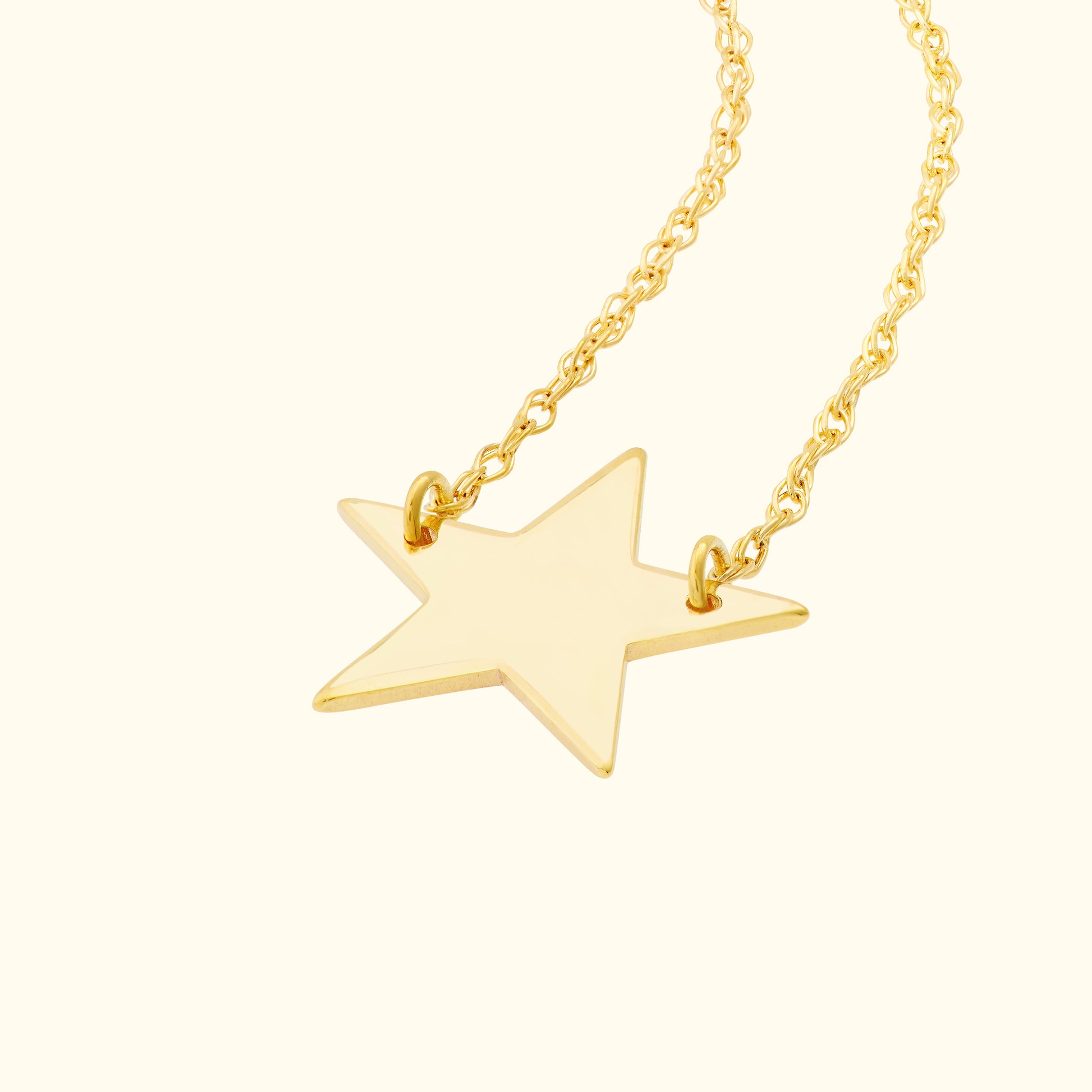 Gold star pendant necklace on a twisted chain.