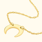 Yellow gold crescent moon pendant on a delicate chain necklace.